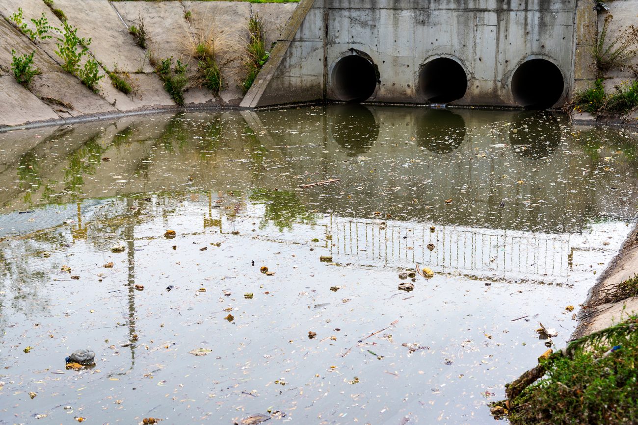 A drain pipe or sewage or sewage discharges waste water into a river. Wastewater or domestic wastewater or municipal wastewater that is a product of a community of people