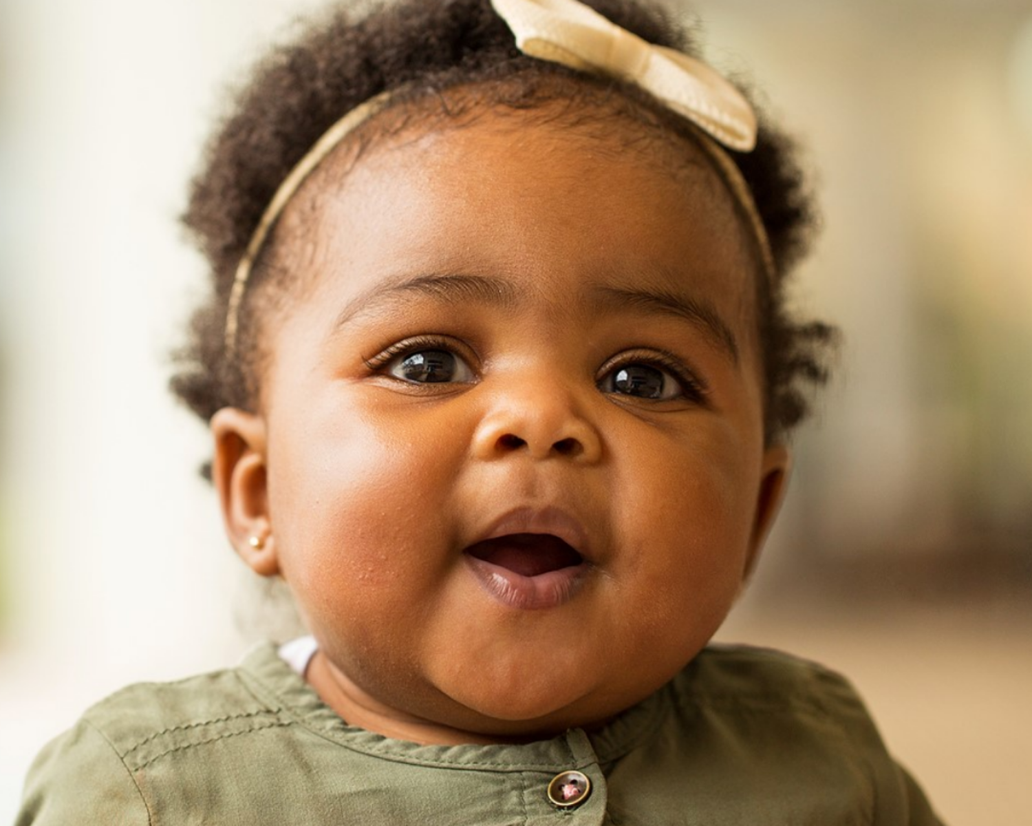 African American baby girl laughing and smiling.
